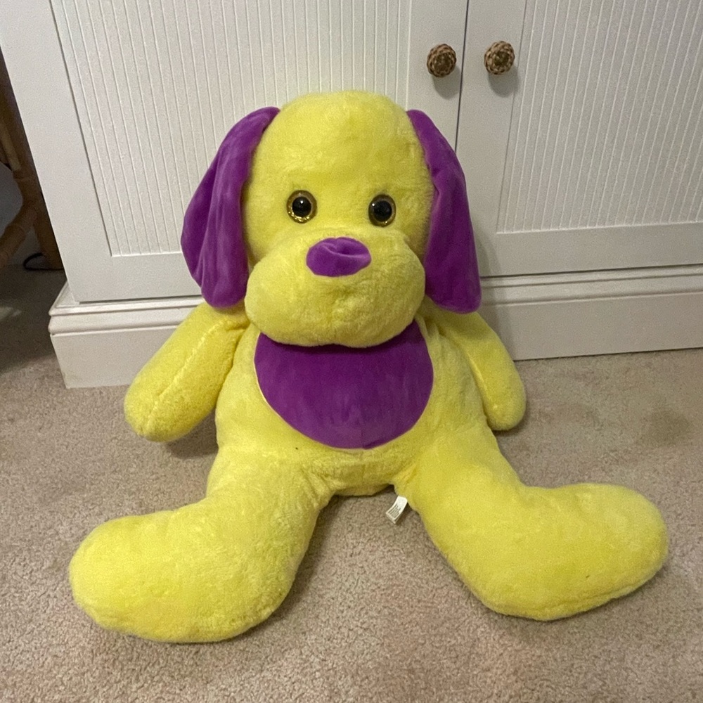 Yellow and purple big stuffed puppy